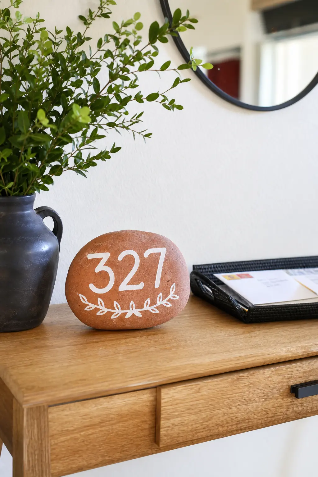 Housewarming Numeral Stones — A terracotta stone with the house number painted in clean white numerals makes a small, sturdy welcome gift for anyone who just