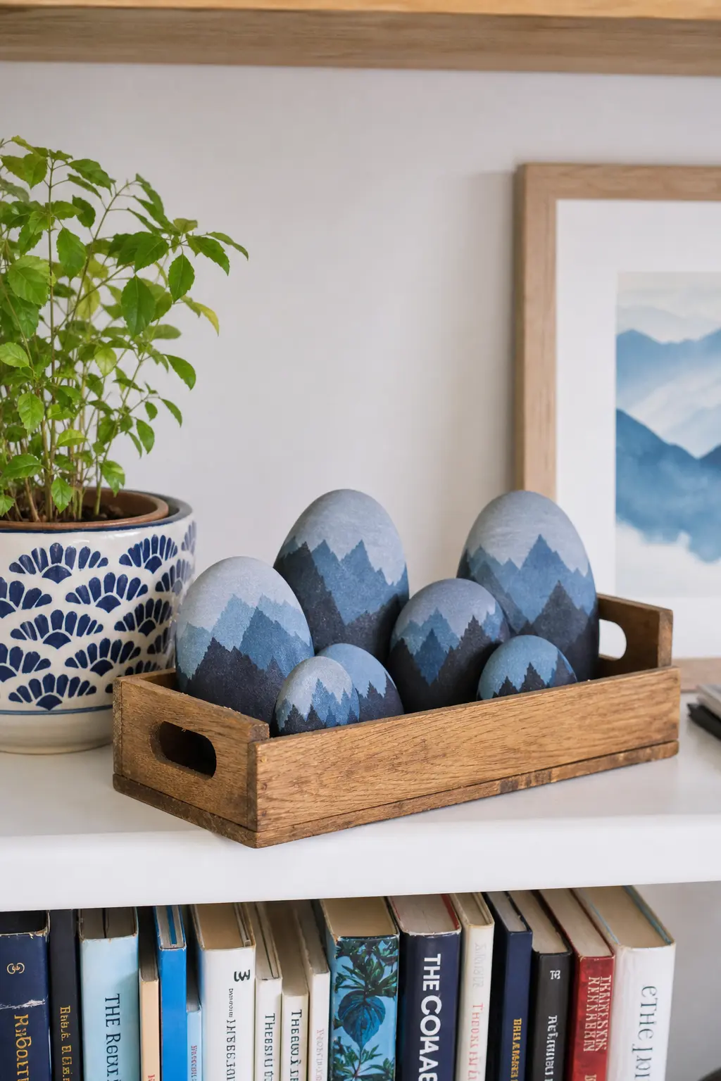 Mountain Range Silhouette Stones — A grey to blue ombre wash across the stone, then a single darker silhouette of jagged peaks painted along the bottom edge