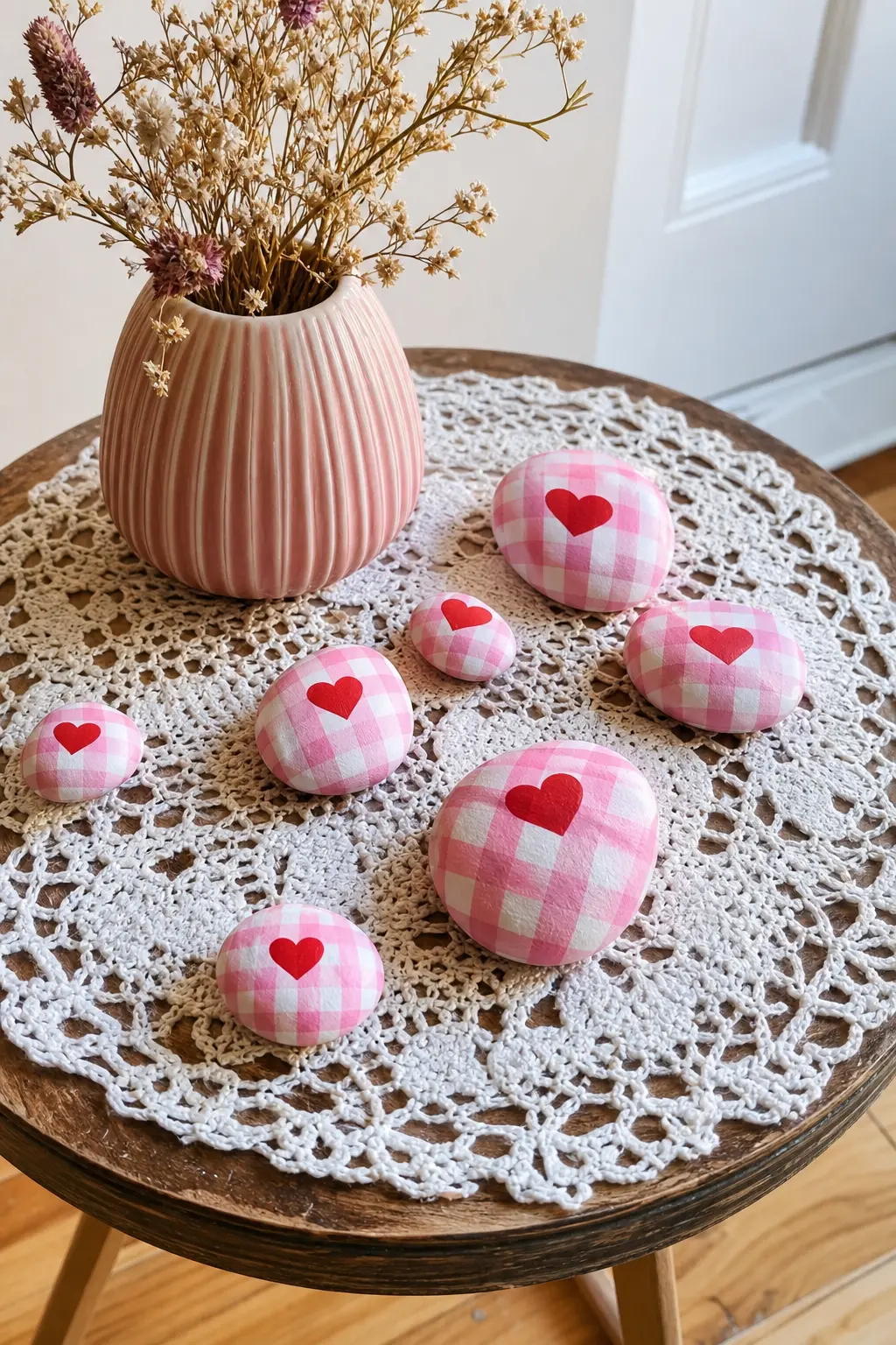Valentine Heart and Gingham Stones — Soft pink stones with a checked gingham base and a single red heart on top sit prettily on a lace tablecloth without ever