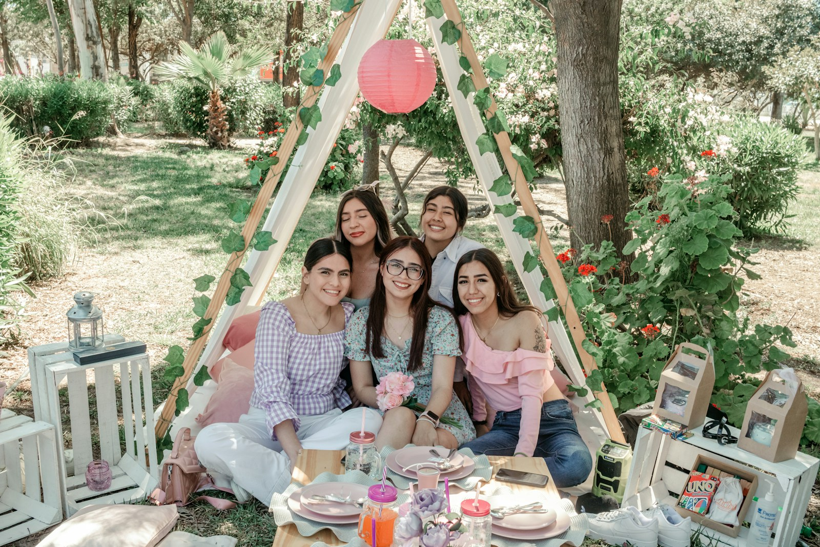 a group of women sitting around a picnic table