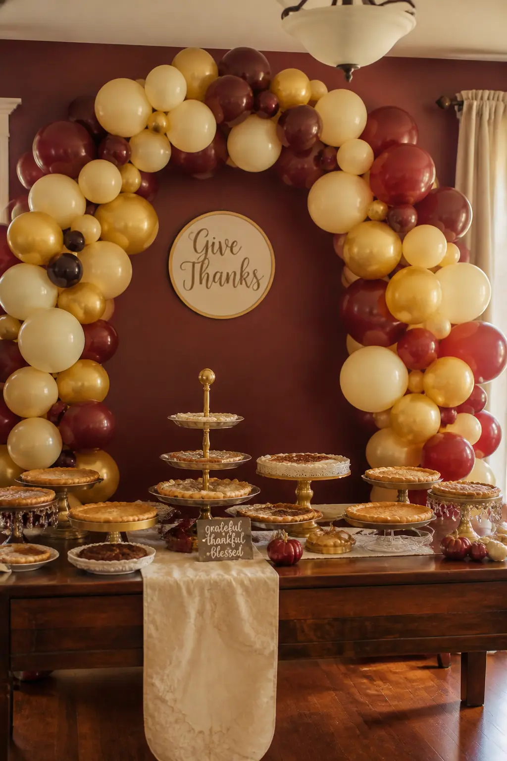 Burgundy, Cream and Gold Arch Behind a Thanksgiving Dessert Table — Place a full arch in burgundy, cream and gold behind a Thanksgiving dessert spread, with