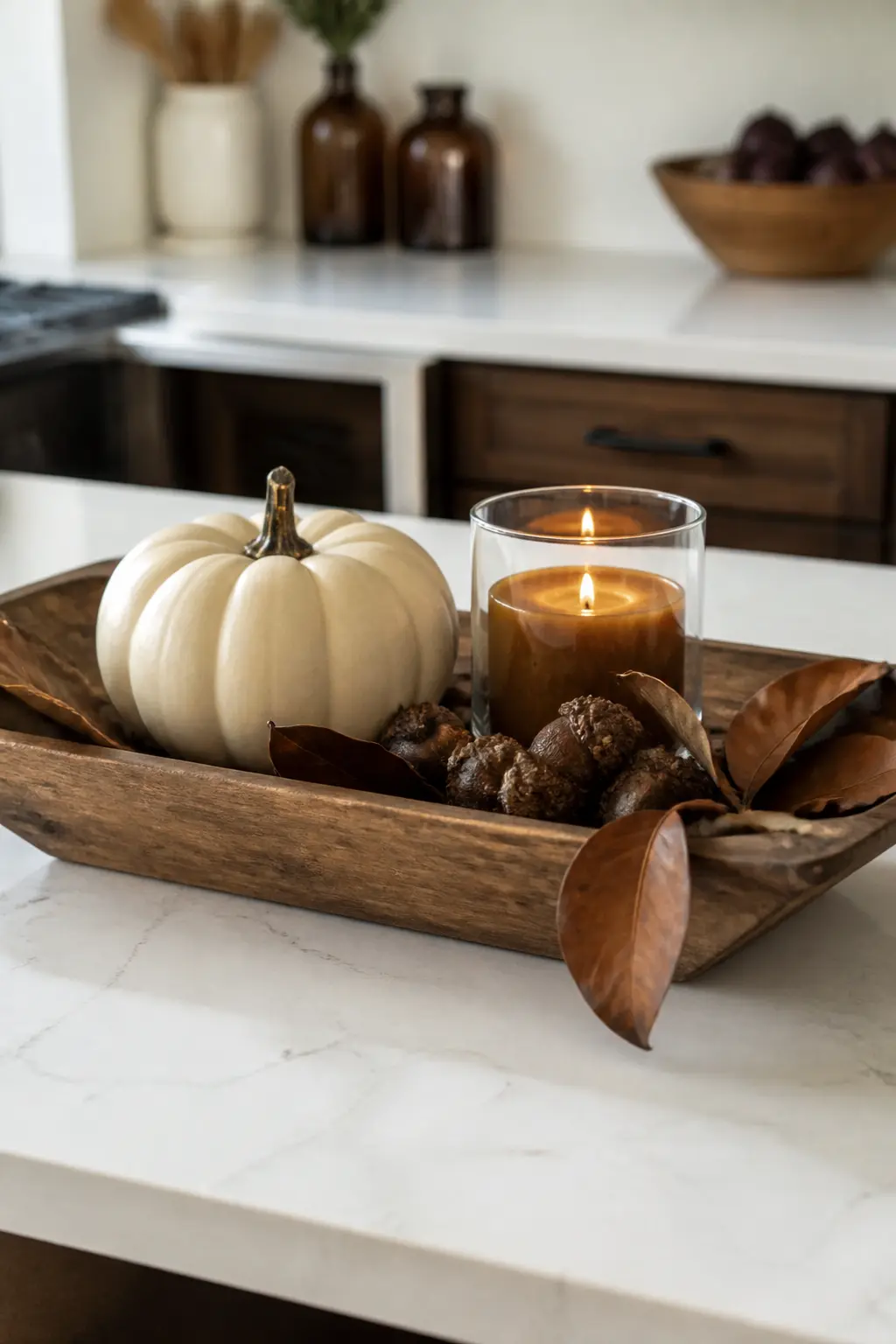 Wood Tray Pumpkin and Candle Vignette — A rectangular handled wood tray, the kind with low sides, holds three elements: a medium cream pumpkin at the back, a