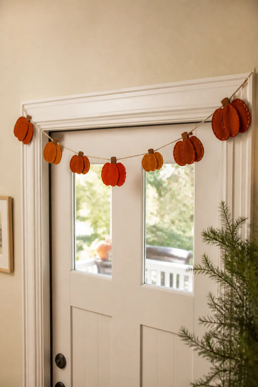 Scalloped Pumpkin Banner — Cut pumpkin silhouettes from three shades of orange-adjacent felt: deep terracotta, burnt sienna and warm amber. Fall felt garland