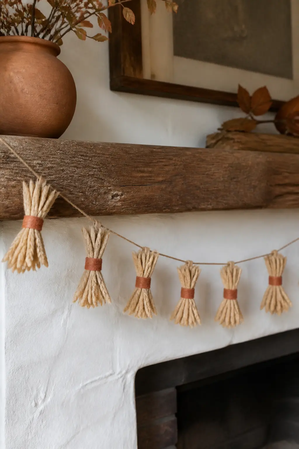 Wheat Stalk Bundle Garland — Cut narrow wheat-stalk shapes from warm sand felt, score a centre vein lightly with a craft knife for texture, then group three or
