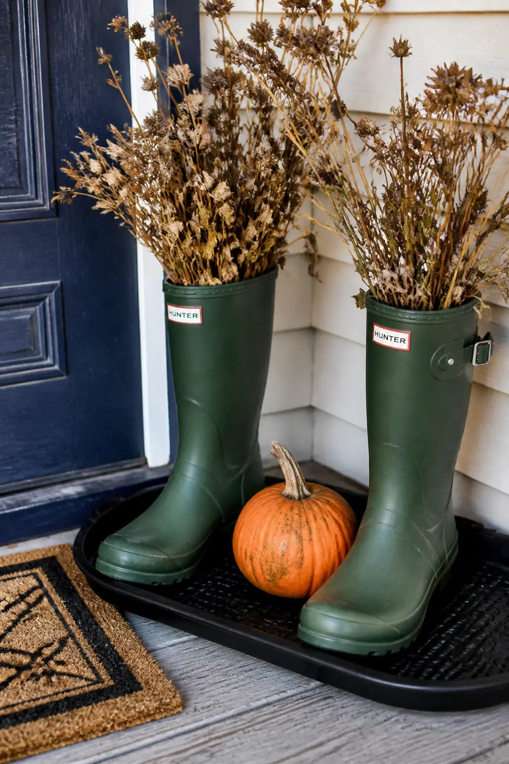 Boot Tray With Rain Boots and a Small Pumpkin