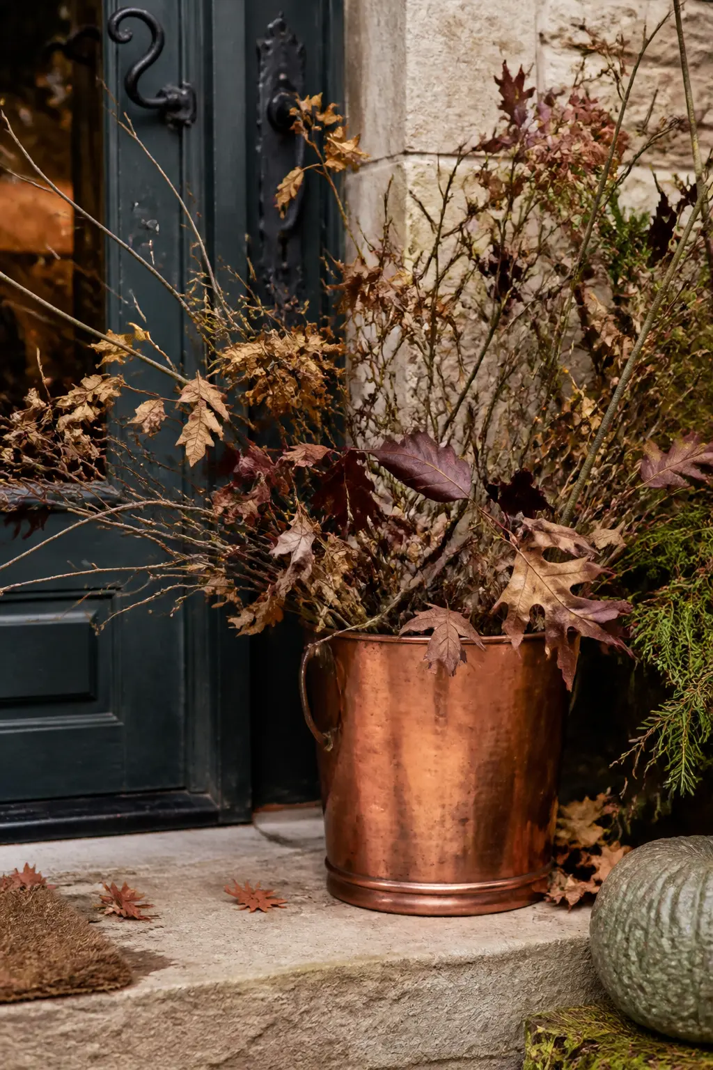 Copper Bucket of Branches on the Top Step