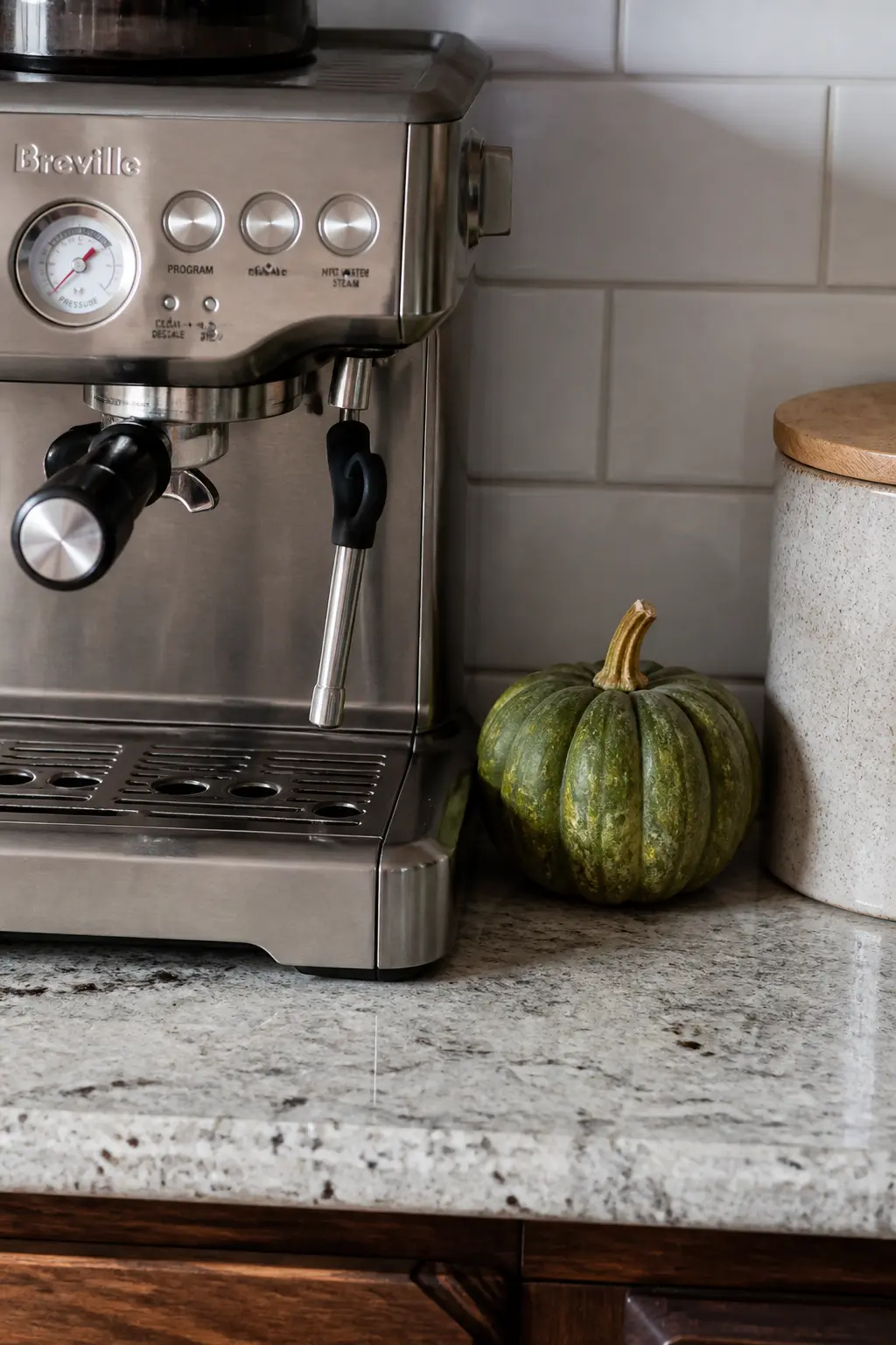 Small Pumpkin Tucked Beside the Coffee Maker