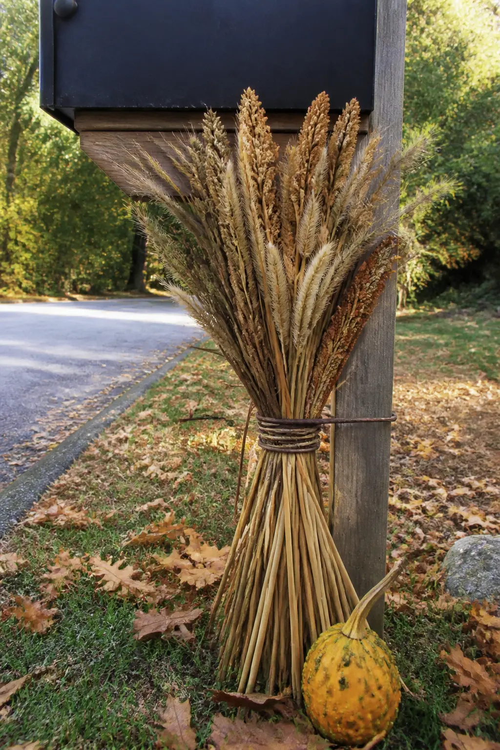 Mailbox Base Wrapped with Dried Stems and a Small Gourd