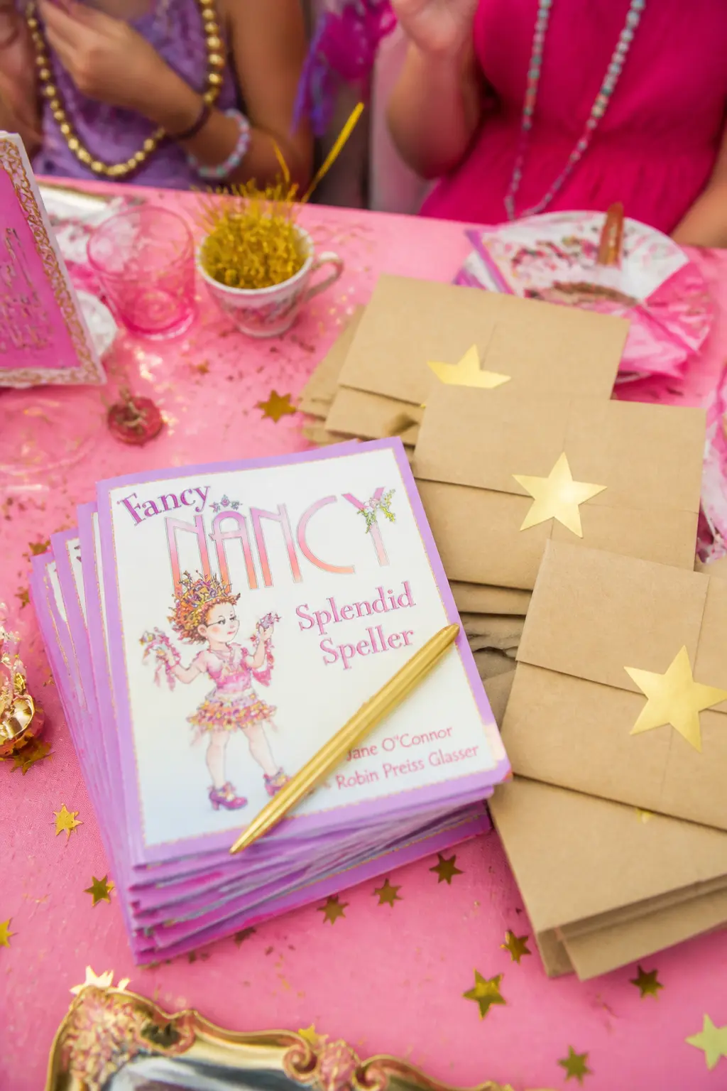Mini Illustrated Book Favour — A small Fancy Nancy picture book slipped into a kraft envelope and sealed with a gold star sticker is a favour that parents