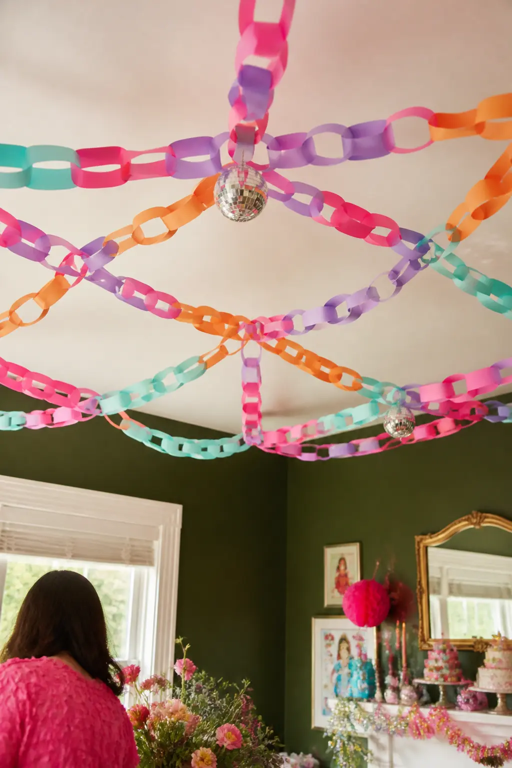 Paper Chain Garland Ceiling Grid — Paper chains hung in a loose grid across the ceiling give the room a confetti-tent effect for almost no money. Fancy Nancy