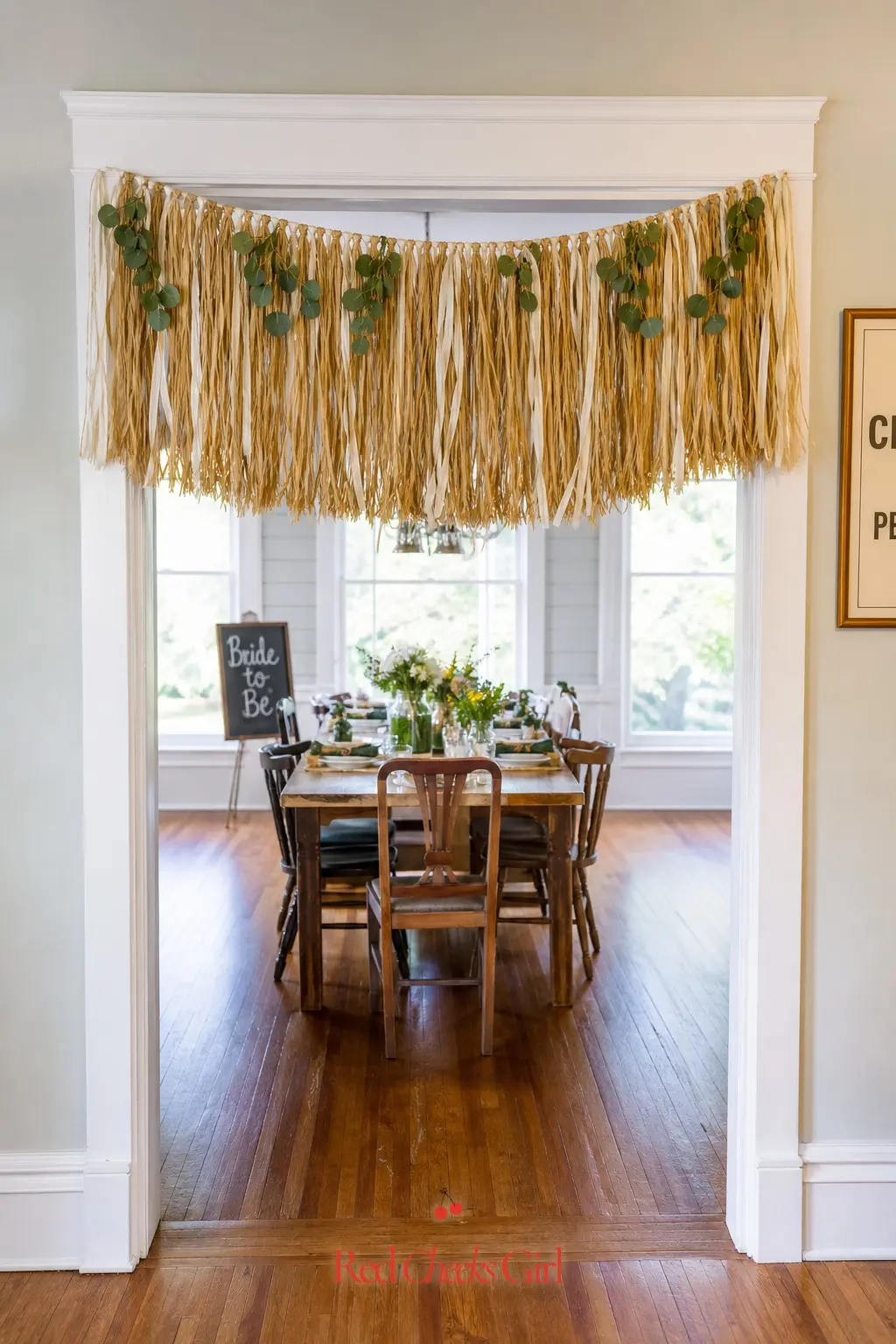 Golden Raffia Fringe Garland — A fringe garland made from raffia rather than paper or plastic keeps the whole doorway on theme without another single-use
