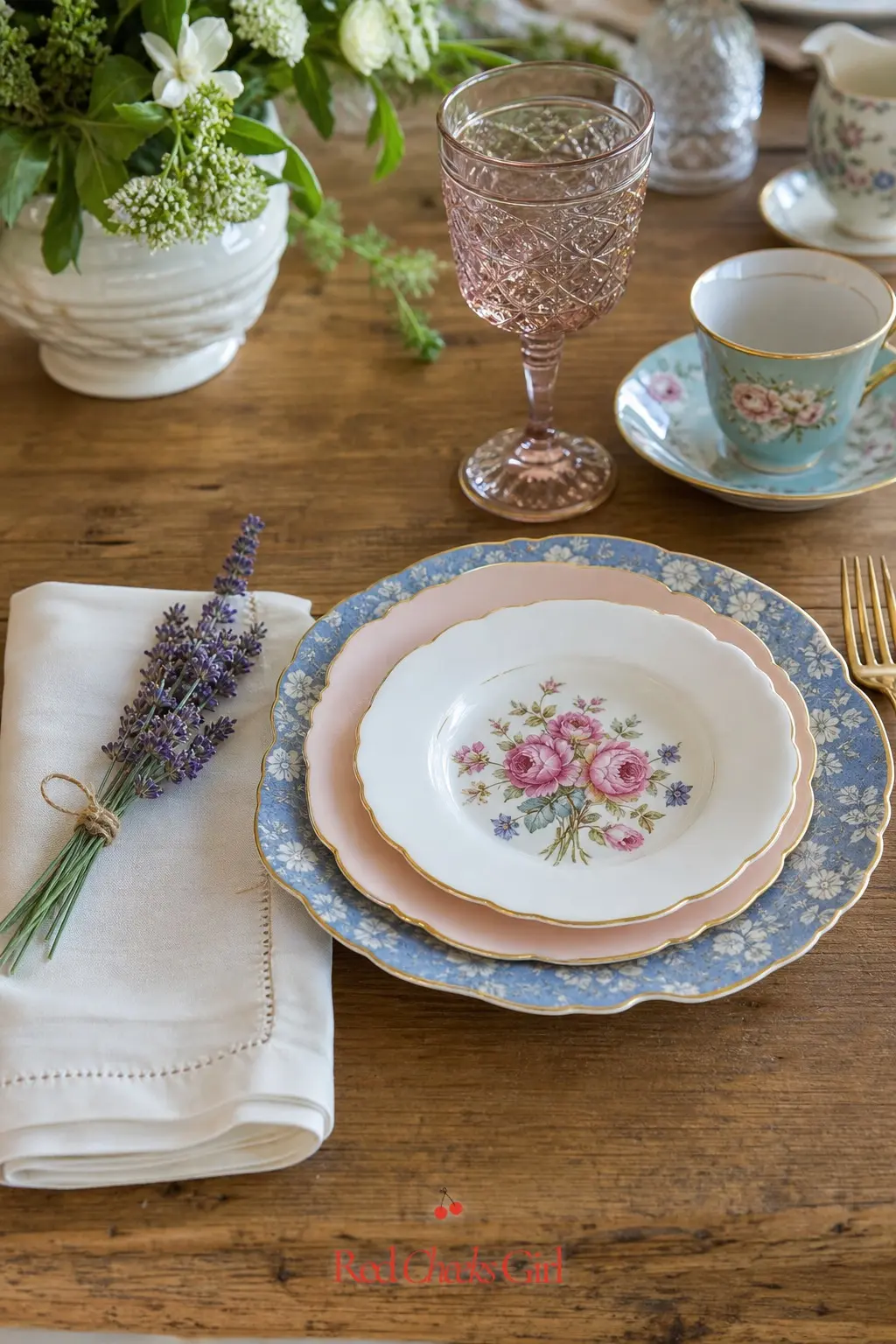 Mismatched Vintage China Place Setting — A run of mismatched vintage plates, in dusty blue and blush pink with a little gold at the rim, looks collected rather