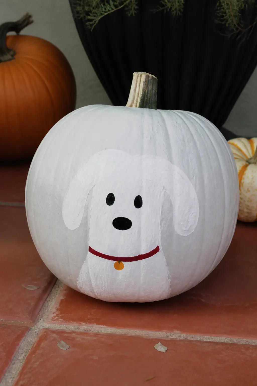 Ghost Dog With a Painted Collar — Floppy ears hanging down on each side of the ghost's head, a short snout, and a stripe of painted collar at the neck turn the