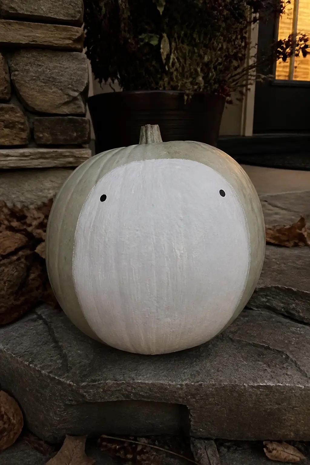Ghost With the Eyes Placed Too Far Apart — The face looks correct from a quick glance. Ghost painted pumpkin