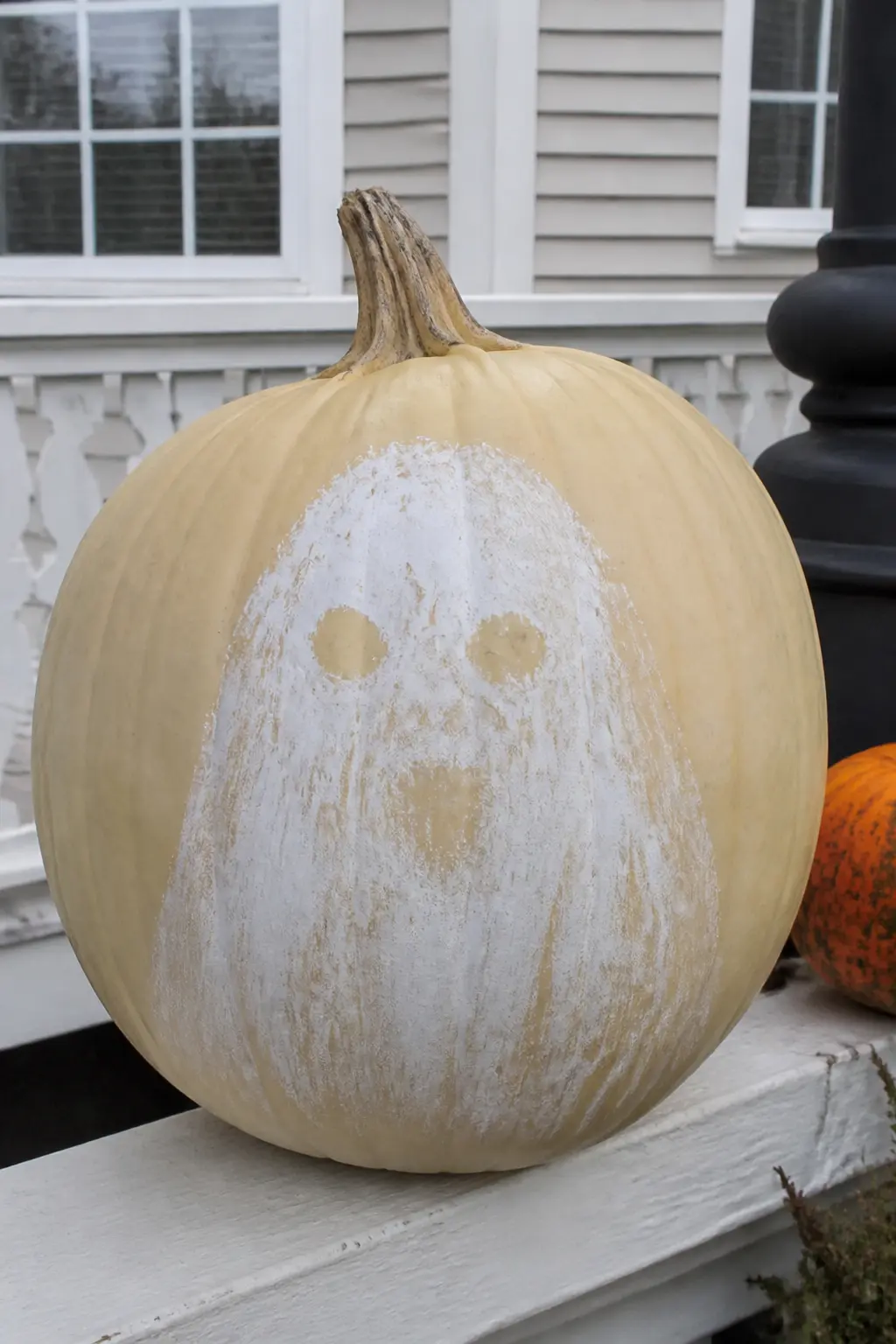 Ghost With a Face That Only Resolves at a Distance — Up close, the ghost's face is a scatter of pale marks, too diffuse to read as eyes or a mouth. Ghost