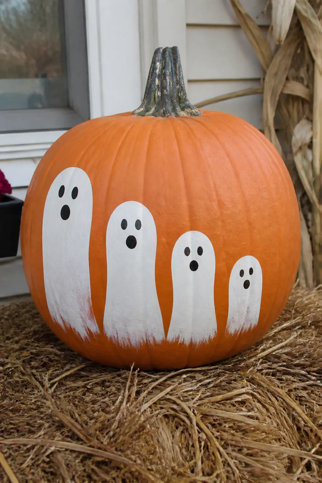 Ghost Family in Graduated Sizes — Three or four ghosts stand in a row, each one a different height: tallest at one end, smallest at the other. Ghost painted