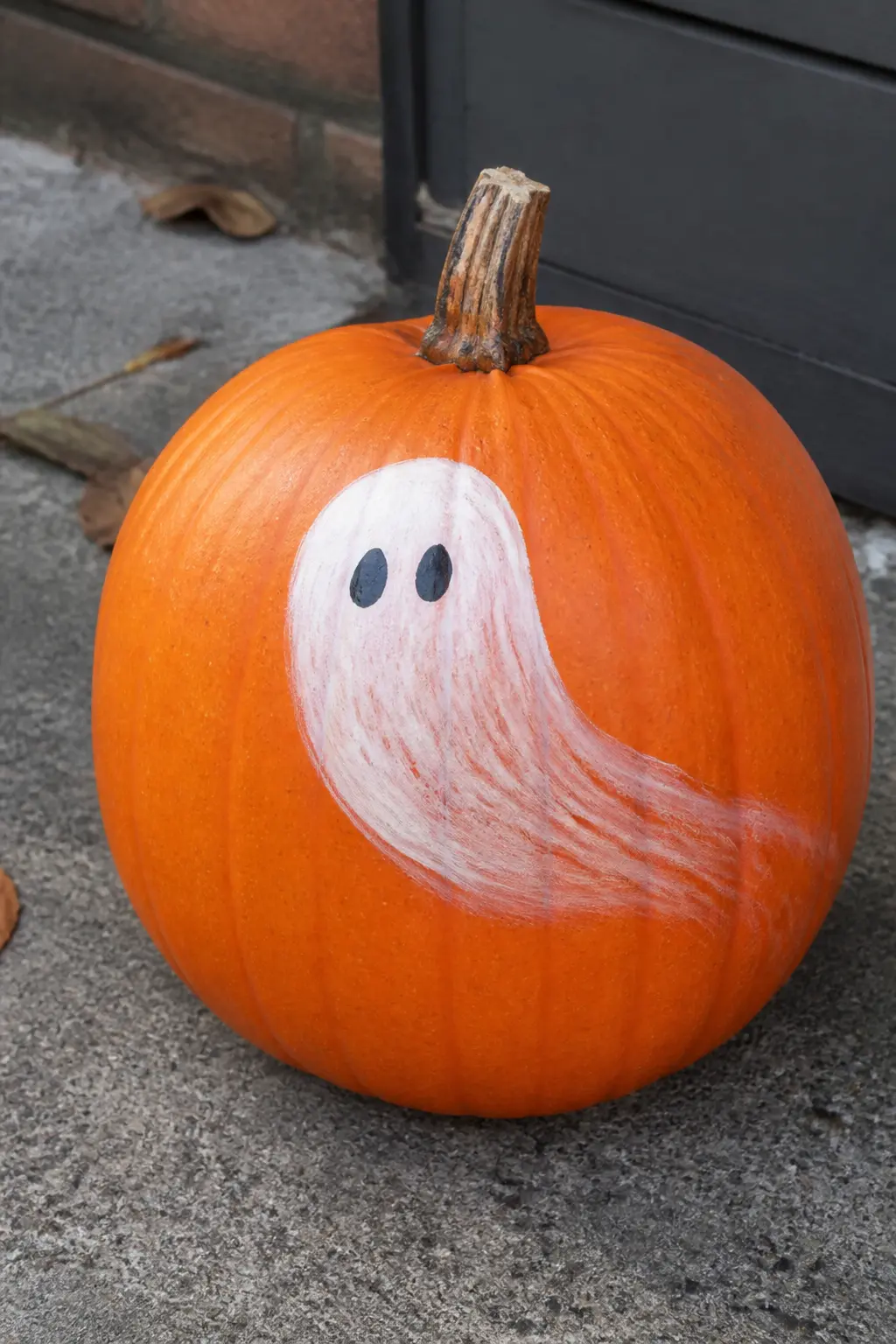 Ghost Mid-Float With a Trailing Tail — The ghost's hemline curves and lifts to one side, as if caught mid-drift. Ghost painted pumpkin