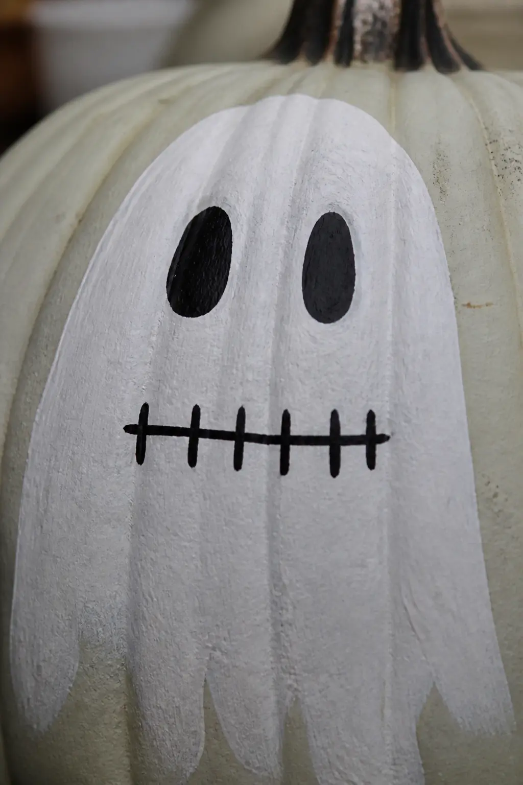Ghost With the Mouth Stitched Shut in Painted Lines — A horizontal line where the mouth would be is crossed by short vertical stitches at even intervals