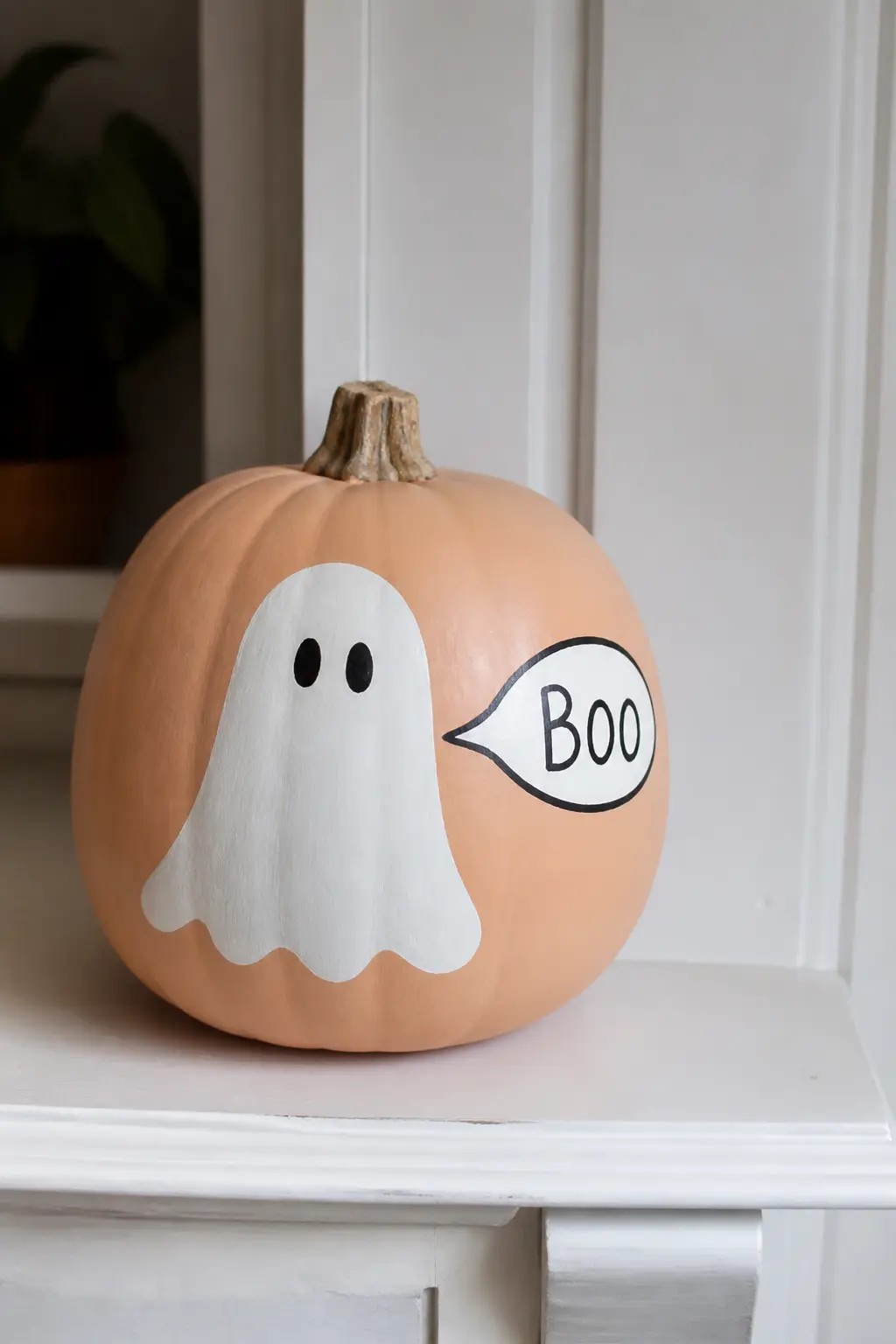 Ghost With a Speech Bubble — A small white oval speech bubble extends from the ghost's mouth area, with a word or short phrase painted inside in black. Ghost