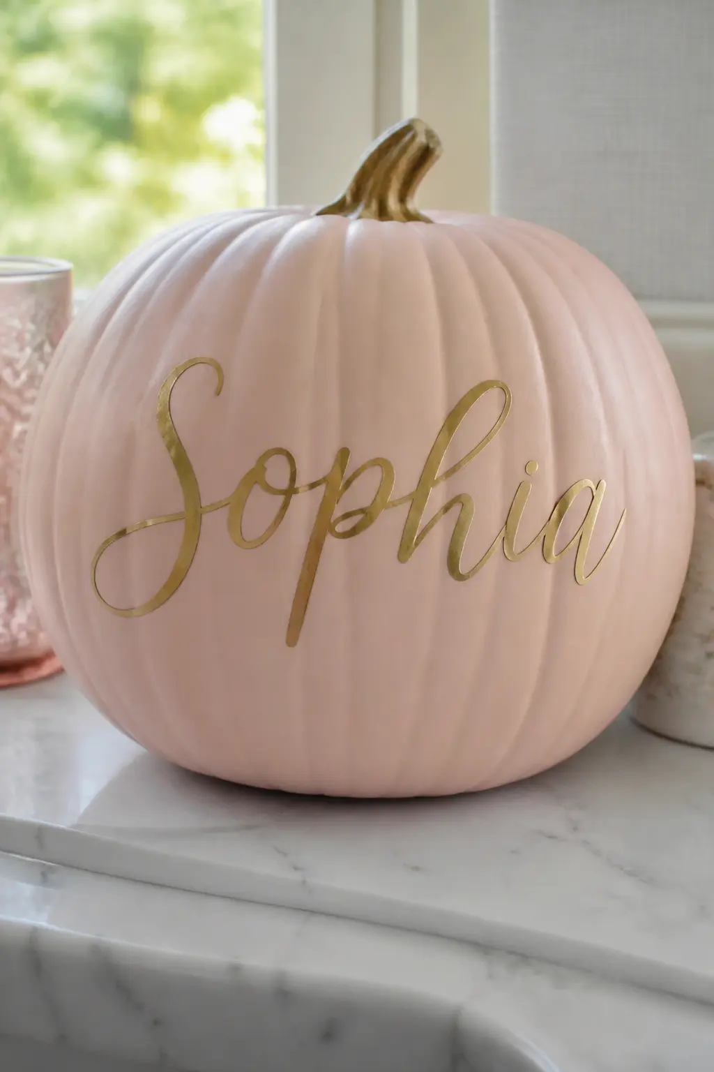 Blush Pumpkin With a Name Hand-Lettered in Gold Script — Paint the pumpkin blush and finish with a matte sealer so the paint pen or brush has a stable surface.