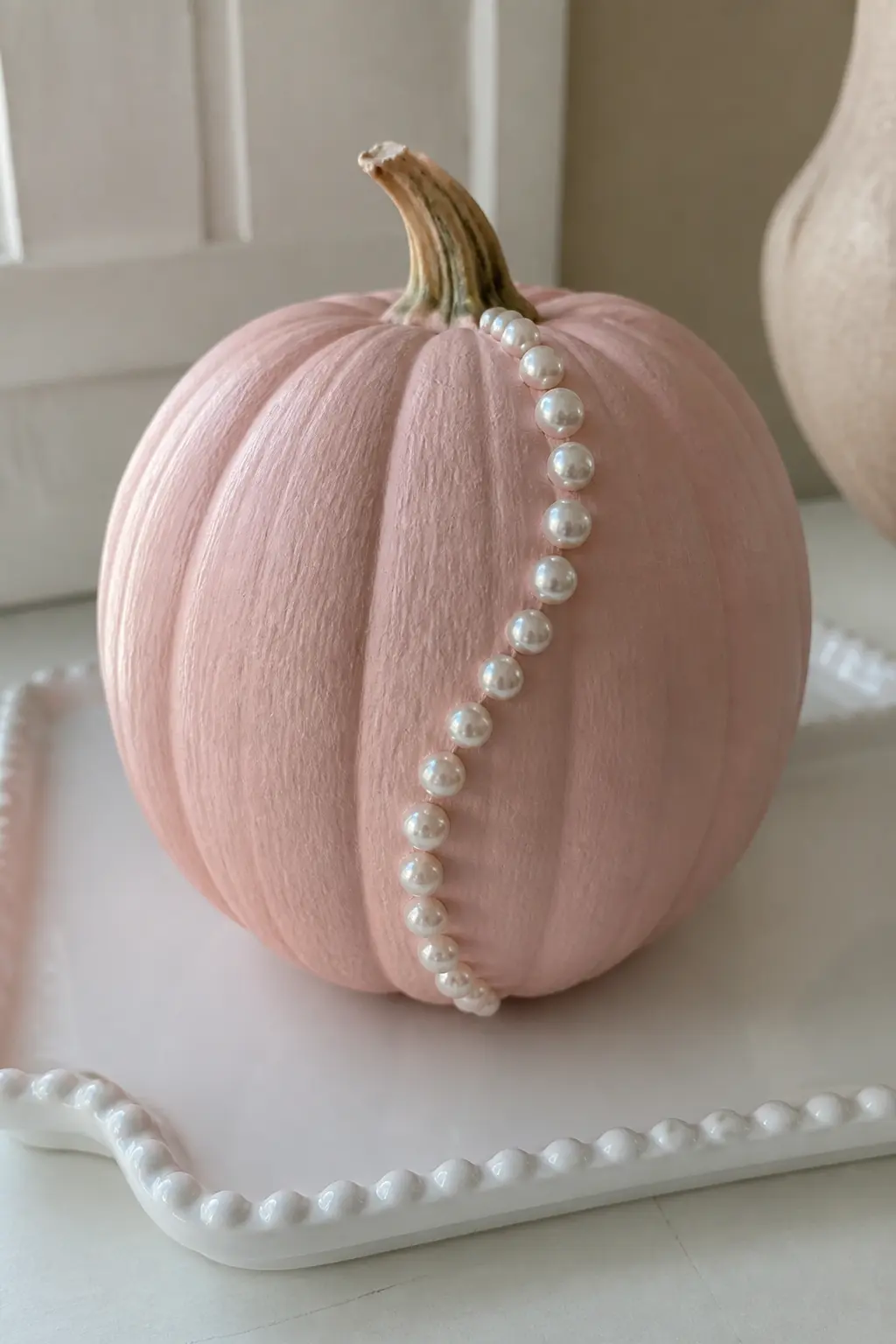 Blush Pumpkin With Pearls Glued in a Curving Line — Sketch a gentle S-curve in pencil from the stem down to the base on one side of the pumpkin. Girly painted