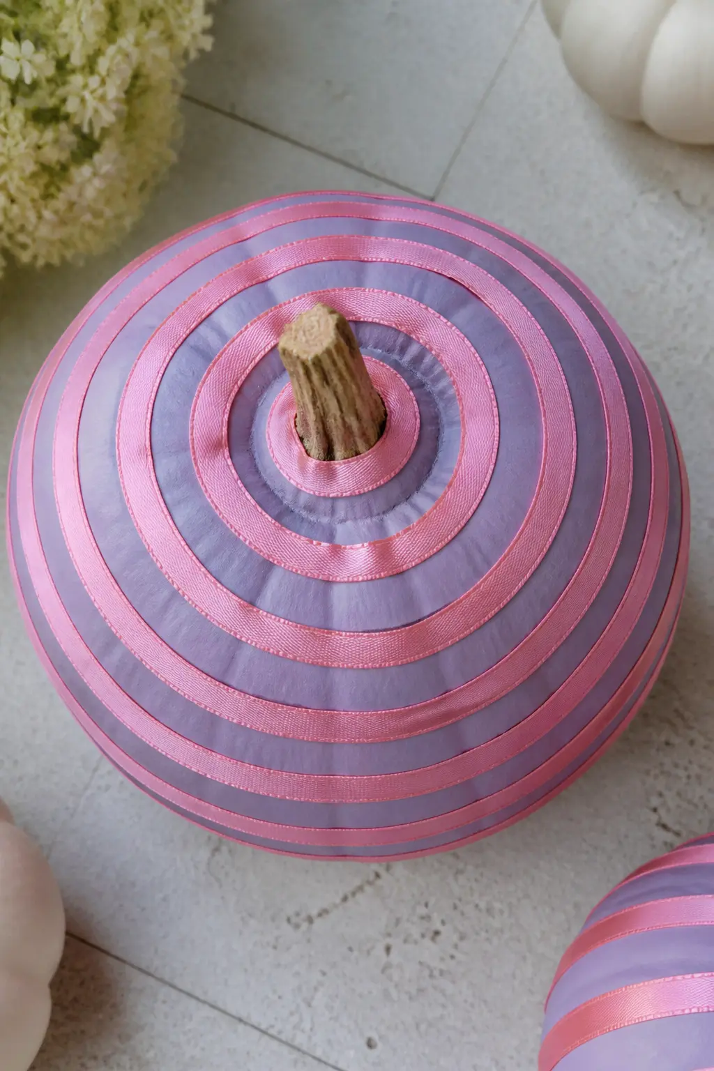 Lilac Pumpkin With Pink Satin Ribbon Wound in a Spiral — Start at the base of the stem and wind a length of narrow pink satin ribbon in a tight spiral, angling