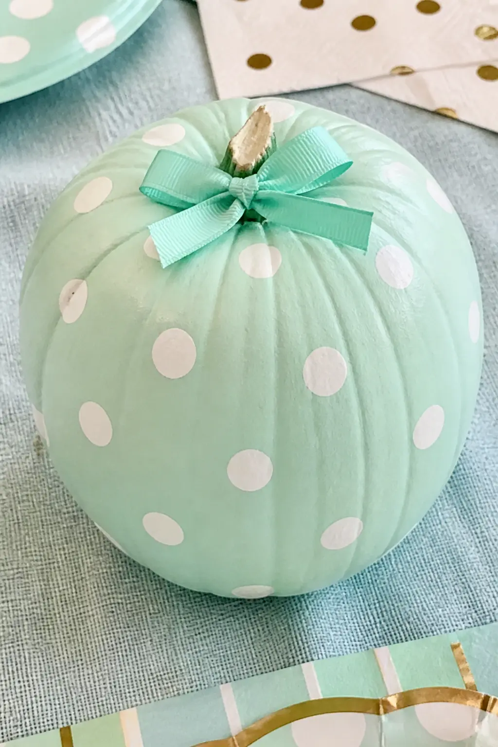Mint Pumpkin With White Polka Dots and a Mint Bow — Paint the pumpkin in cool mint and let it dry overnight. Girly painted pumpkin