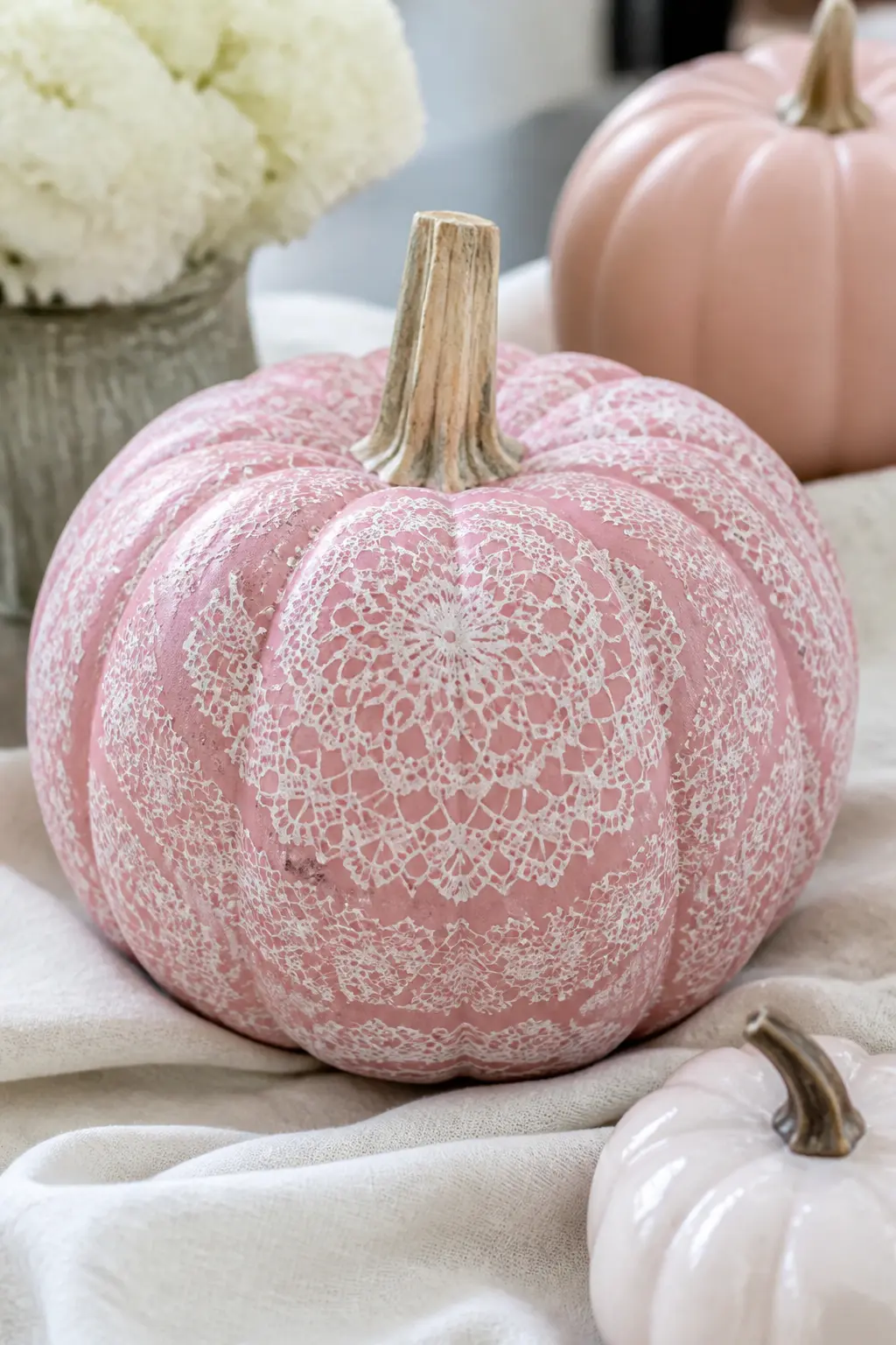 Pink Pumpkin With Painted White Lace Pattern Sponged Through a Doily — Paint the pumpkin in warm pink. Girly painted pumpkin