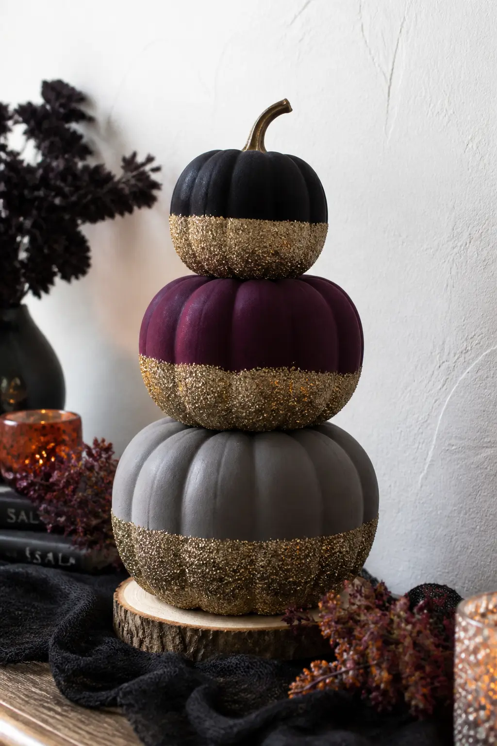 Glitter-Dipped Foam Pumpkin Stack — Stack three foam craft pumpkins in descending sizes on a wooden slice or a small cake stand. Glitter crafts