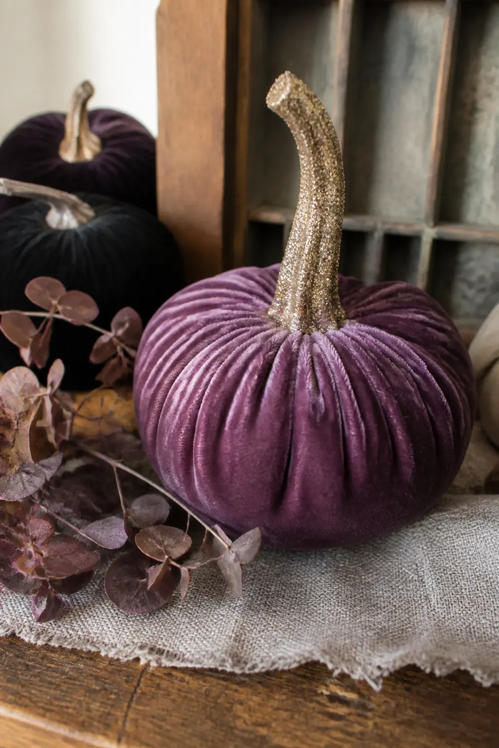 Glitter-Stem Velvet Pumpkin — Buy or make a plain velvet pumpkin, which has a textile body that completely solves the glitter-shedding problem because nothing