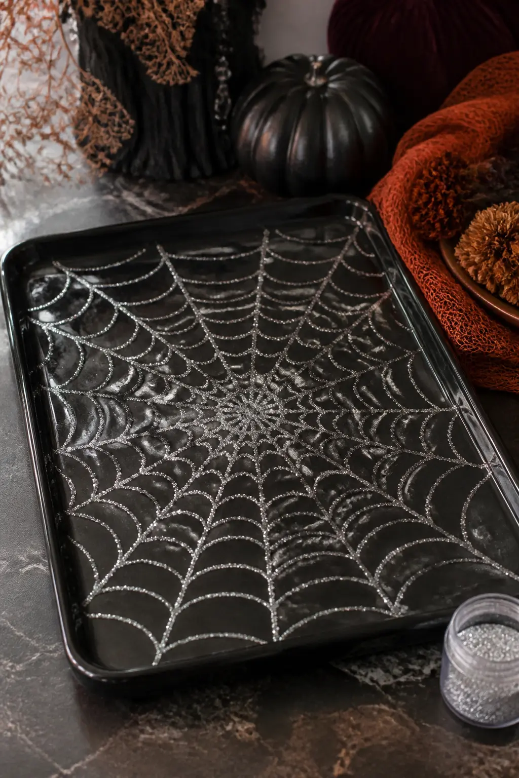 Monochrome Silver Web Tray — Take a plain black wooden or lacquered tray and draw a spider web across the entire surface in dimensional fabric paint, which has