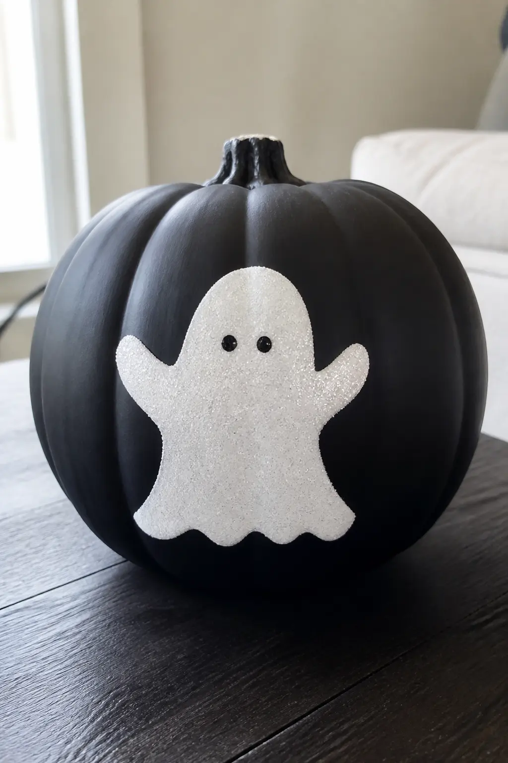 Black Pumpkin With a White Glitter Ghost Silhouette — Paint the pumpkin matte black. Glitter pumpkin