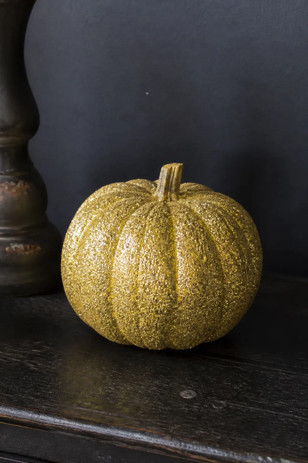 Gold Glitter Pumpkin Over a Black Base — Paint the pumpkin matte black and let it cure for a full day