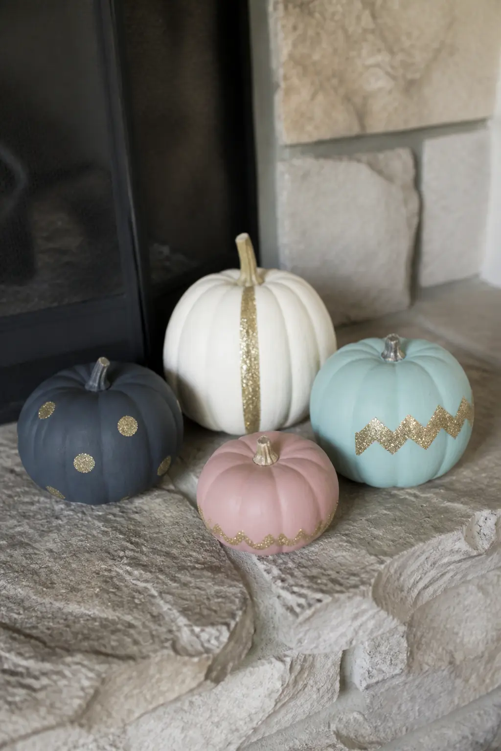 Set of Matte Painted Pumpkins Each With One Glitter Accent — Paint four or five pumpkins in different matte colours and give each one a single different