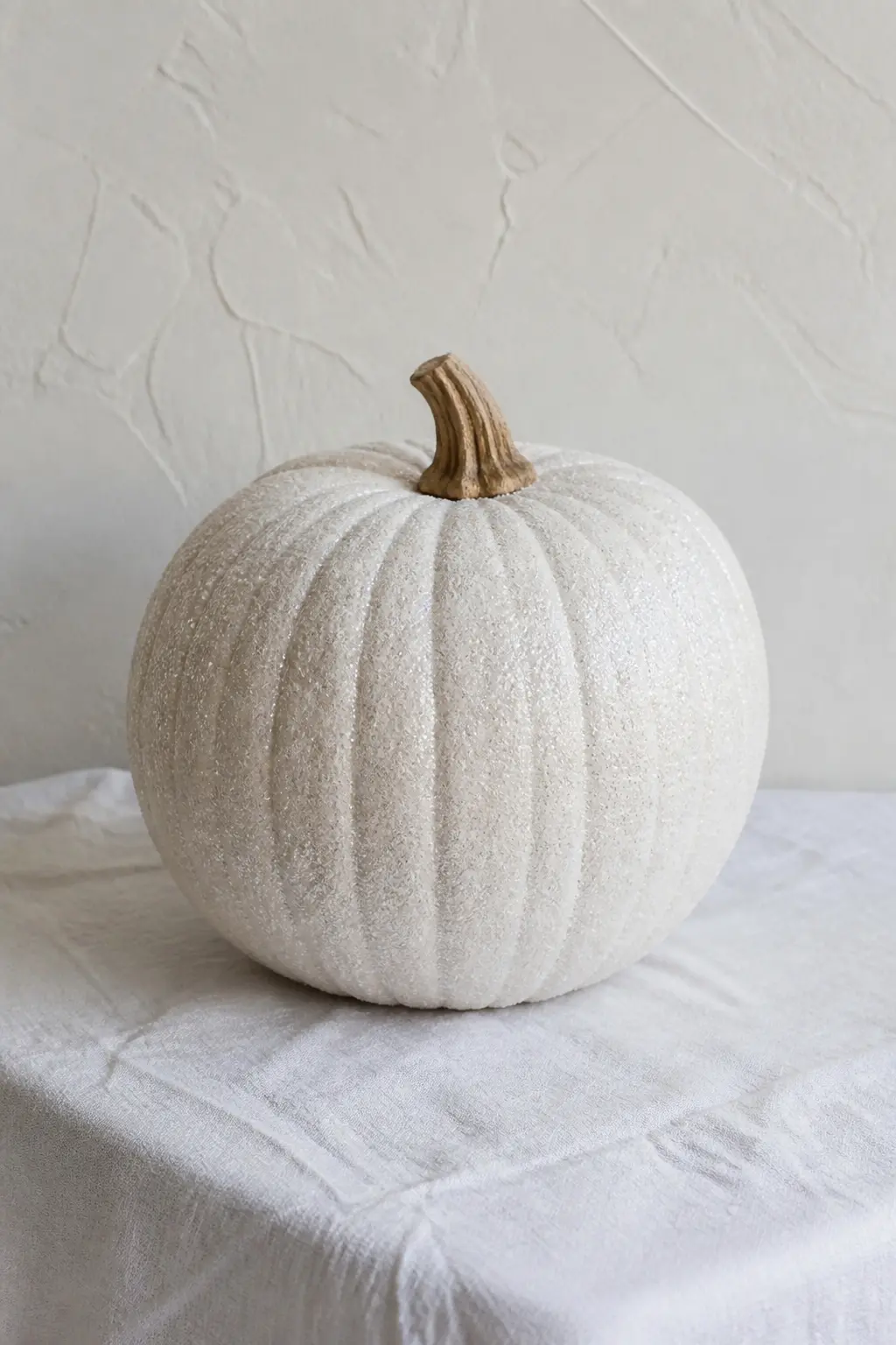 White Glitter Pumpkin on a White Base — Paint the pumpkin bright white, two coats