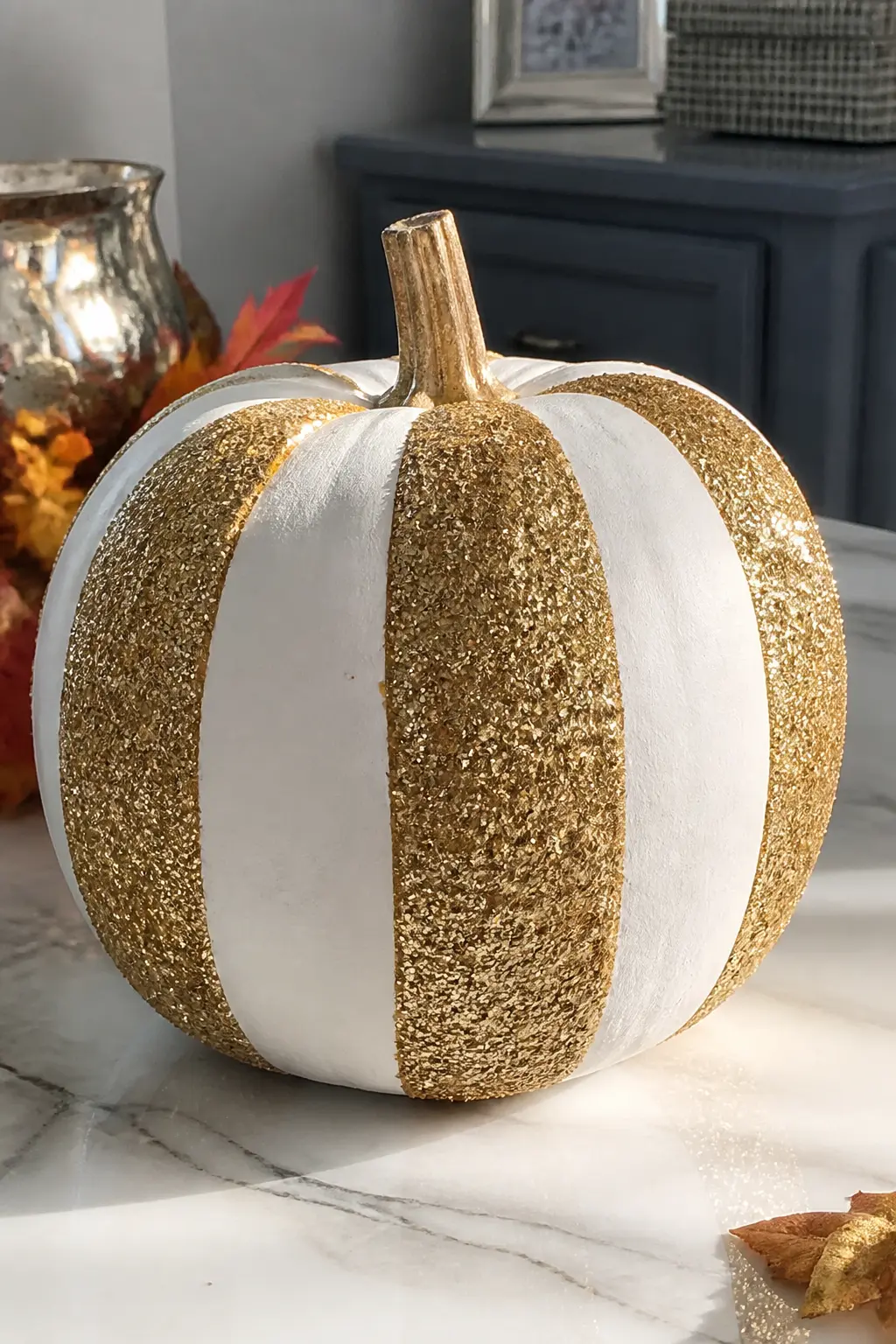 White Pumpkin With Gold Glitter Stripes Masked With Tape — Paint the pumpkin white. Glitter pumpkin
