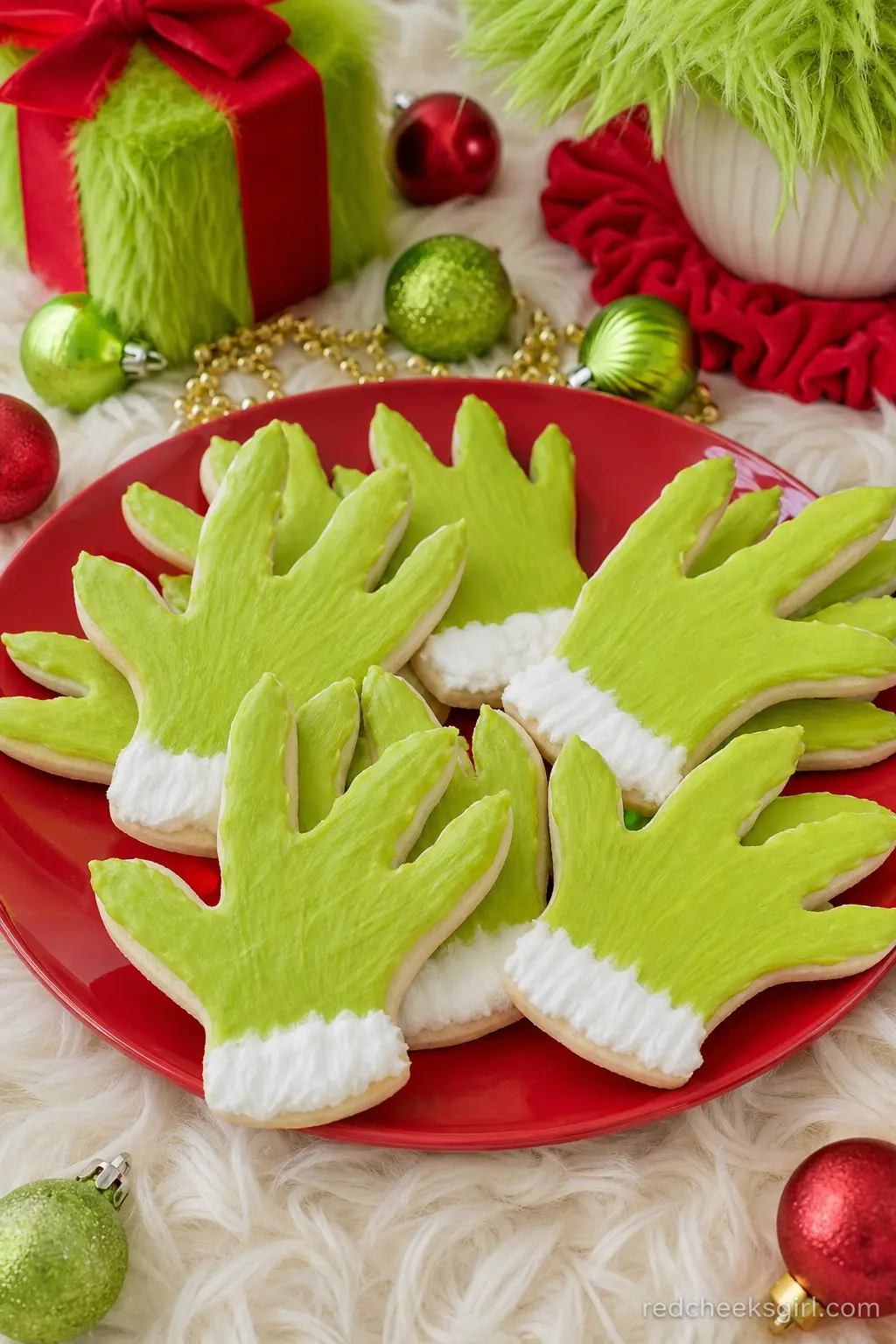 Fuzzy Green Hand Cookies — Sugar cookies iced in matte lime green, cut into a simple clawed hand shape with a white cuff at the wrist, are the single most