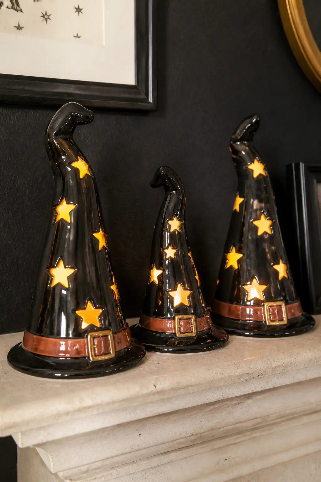 Lit Ceramic Witch Hat Figures — Ceramic witch-hat lanterns with cut-out stars and a battery-operated tea light inside belong on the mantel or a console table