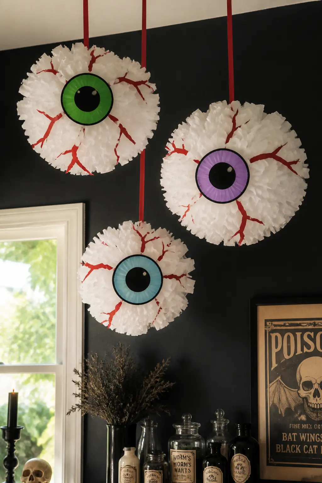 Crepe Paper Eyeball Pom — Make a standard tissue-paper pom in white, then paint or glue a large iris disc to the centre once it is opened and fluffed.