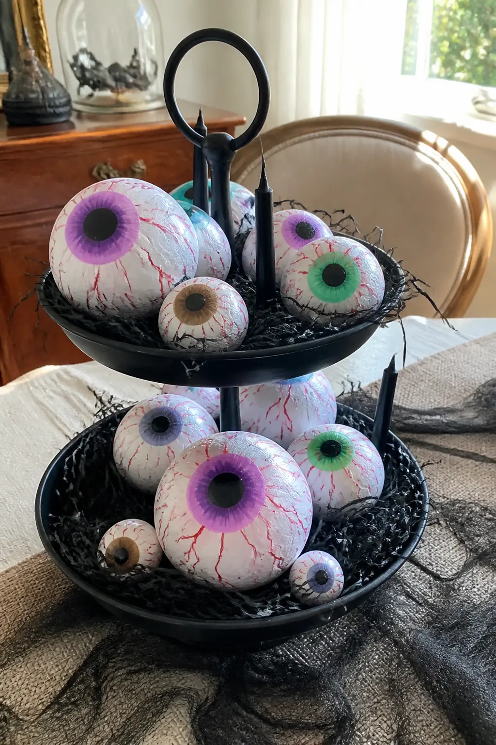 Styrofoam Eyeball Tiered Tray — Paint a set of styrofoam balls as eyeballs in different sizes and scatter them across the tiers of a two-tier or three-tier