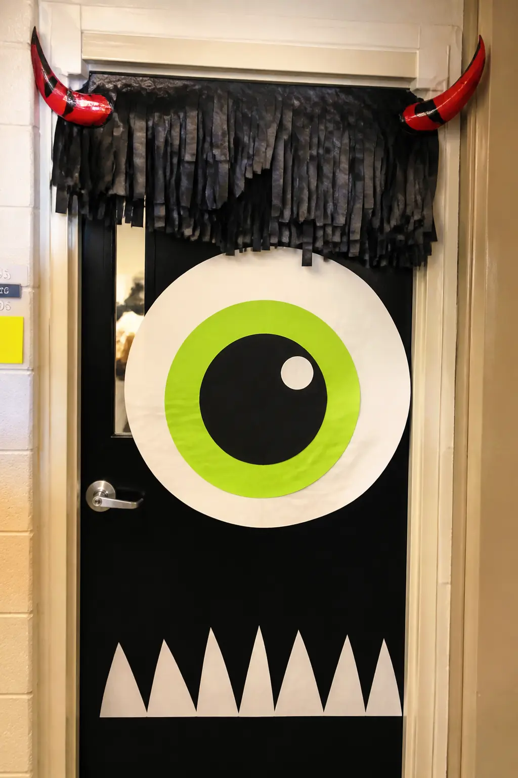 Cyclops Monster Close-Up — One enormous eye centered on the door, made from concentric circles of paper: white, then a large lime-green iris, then a black