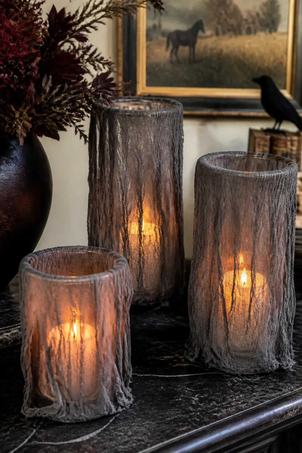 Cheesecloth Draped Candle Lanterns — Take a glass lantern or a tall glass cylinder and drape a length of cheesecloth loosely over the top so it falls in uneven