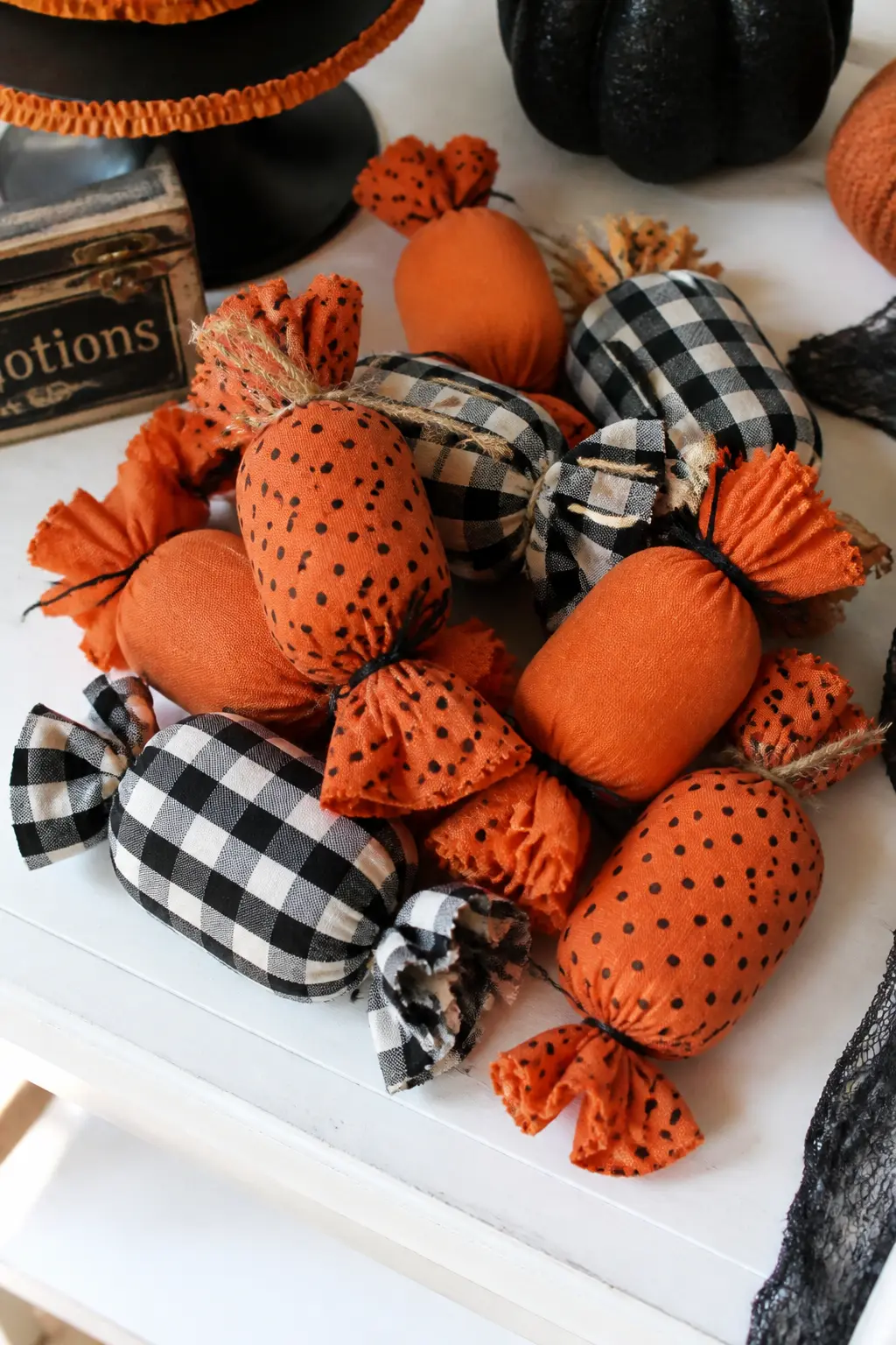 Fabric-Wrapped Candy Pillow Ornaments — Cut a circle of fabric, place a generous mound of polyfill in the centre, gather the edges up around it and twist both