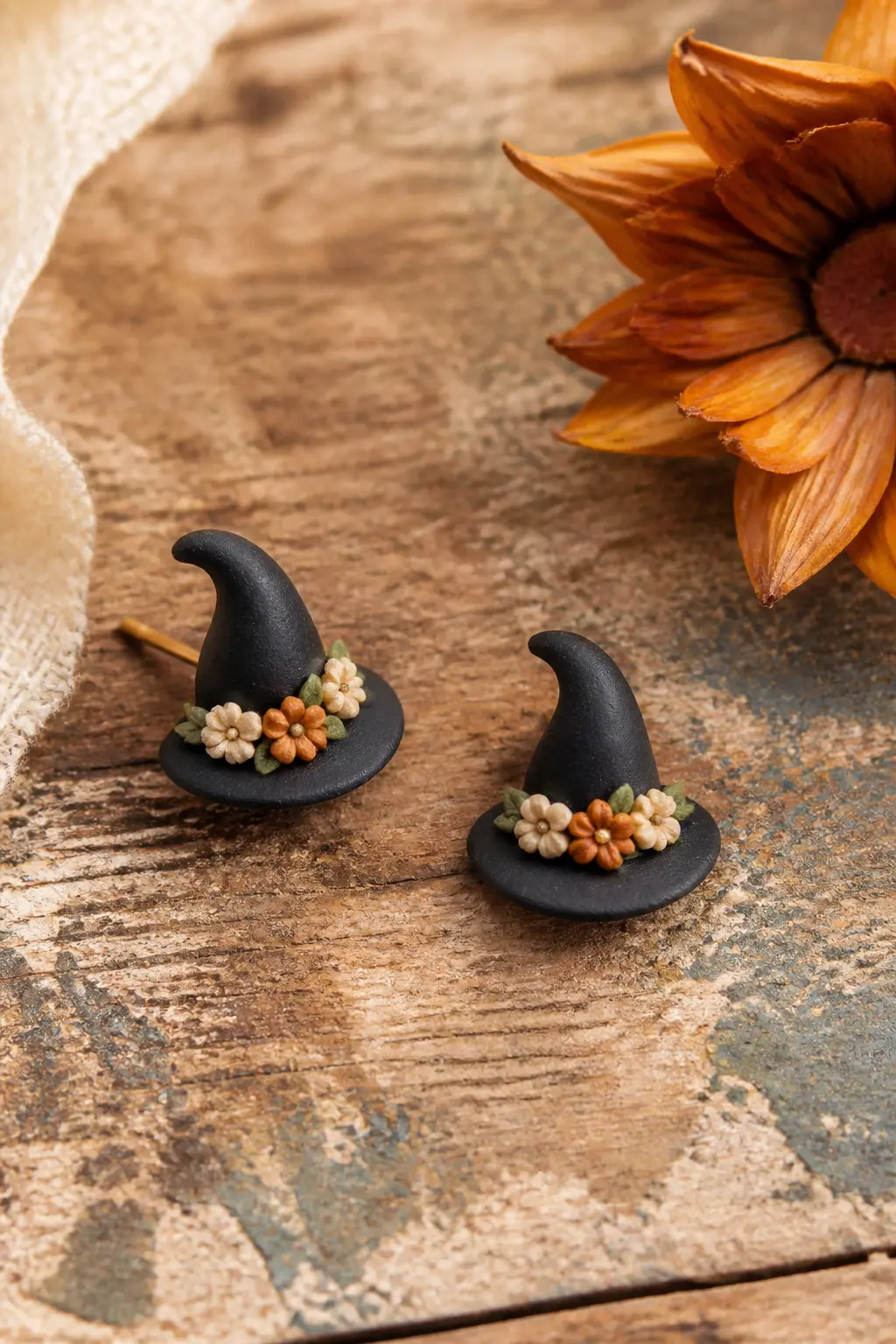 Witch Hat Stud Earrings With Tiny Floral Band — Roll black clay to about 3 mm thickness and cut two mirror-image hat silhouettes freehand: a wide curved brim