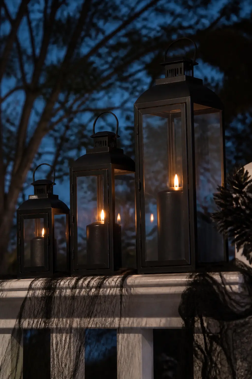 Hurricane Lanterns With Black Candles on the Rail