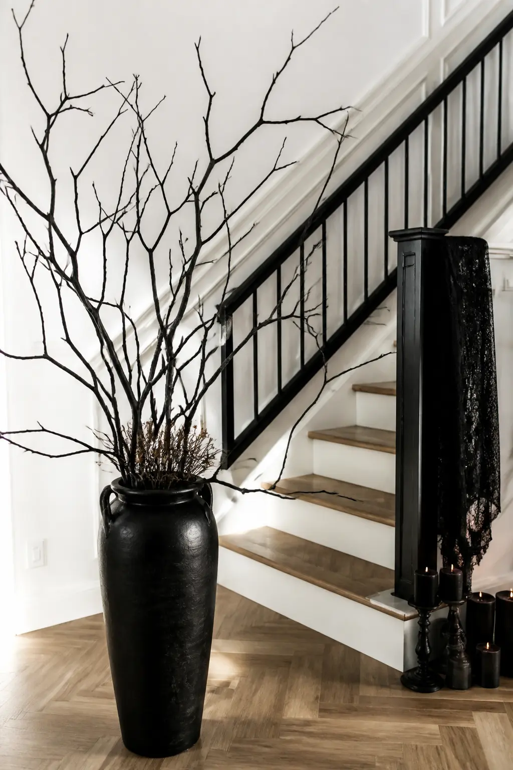 Bare Branch Arrangement in Tall Floor Vase — Fill a tall glass or ceramic floor vase with bare branches sprayed matte black. Halloween staircase decorations