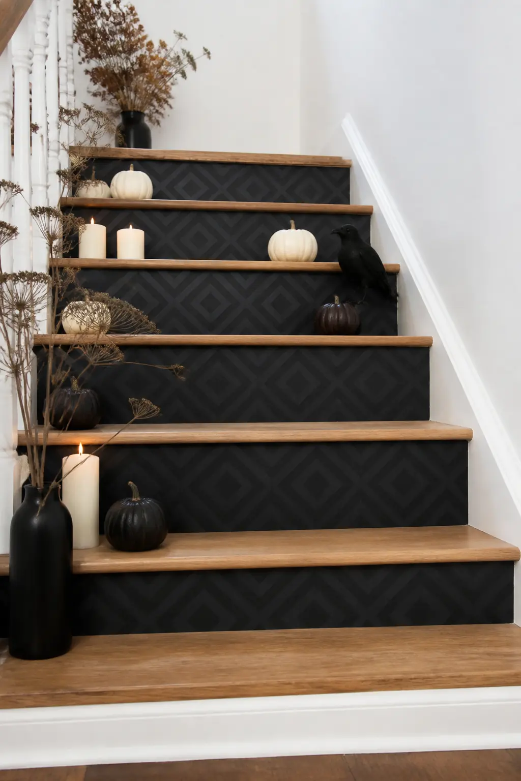 Black Peel-and-Stick Riser Tile — Apply peel-and-stick vinyl tile panels to the risers in a matte black geometric pattern: a simple grid, a herringbone, or a
