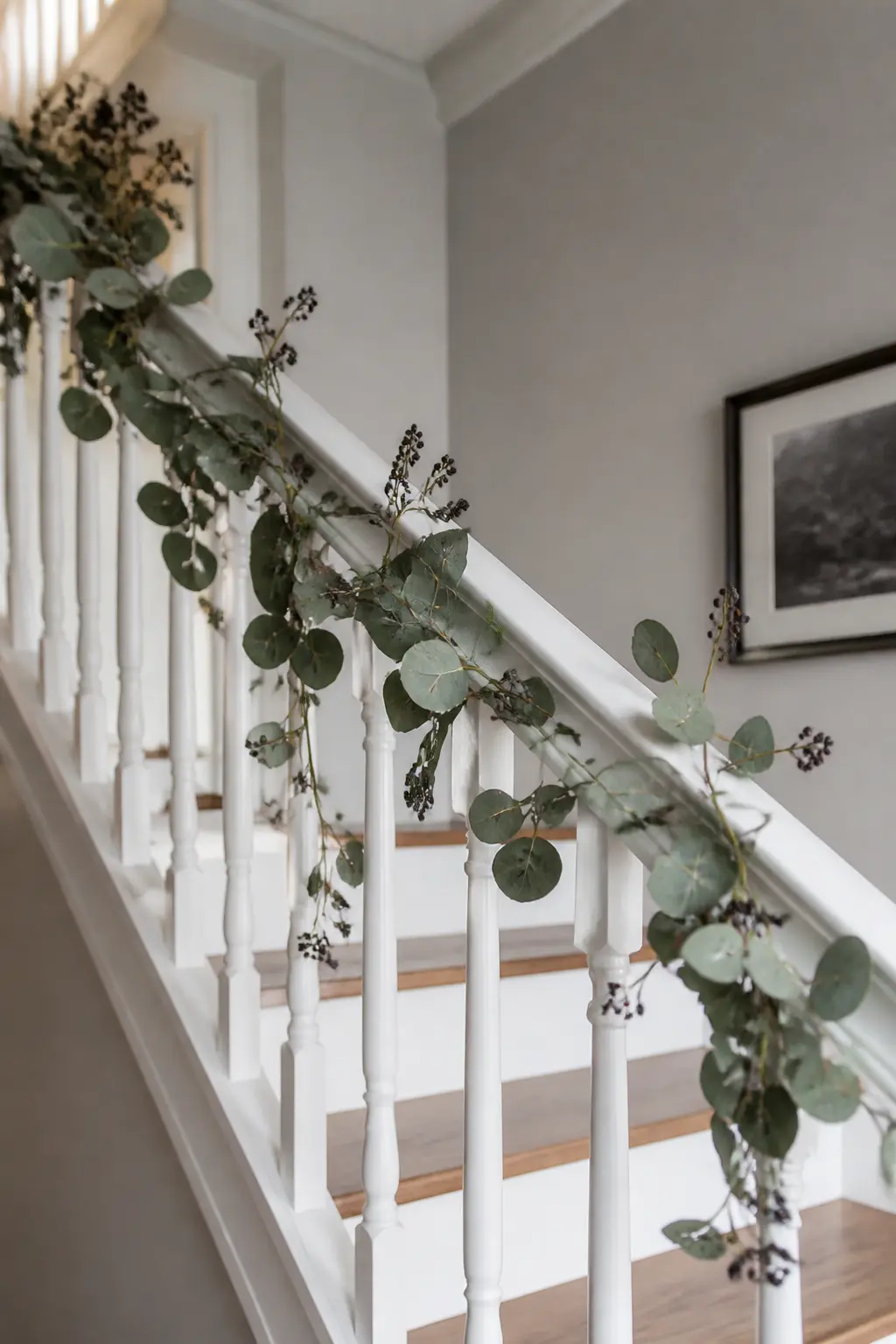 Preserved Eucalyptus and Black Berry Garland — Wind a garland of preserved silver-dollar eucalyptus along the banister, tucking in stems of dried black berries