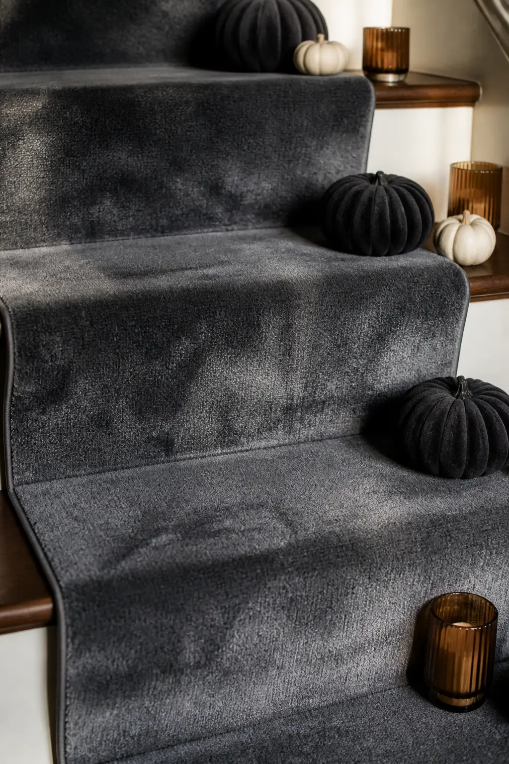 Smoke-Grey Velvet Stair Runner — A temporary velvet stair runner in deep charcoal or smoke grey transforms the whole staircase with a single purchase.