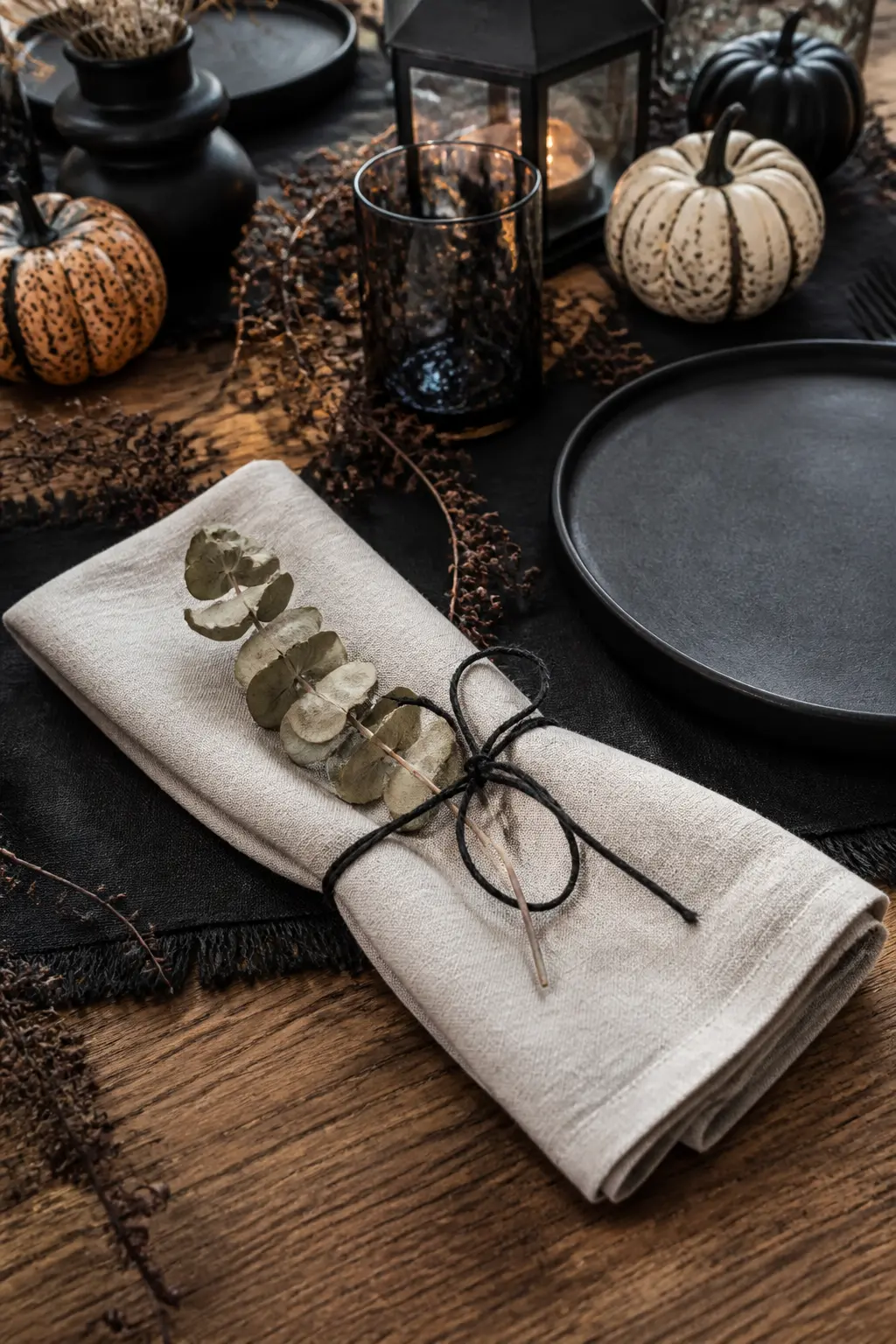 Napkins Tied With Black Twine and a Dried Sprig